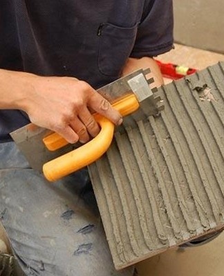 man gluing tiles