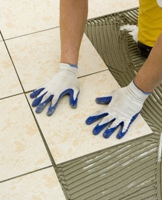 man gluing tiles