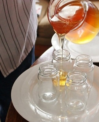 pour honey into jars
