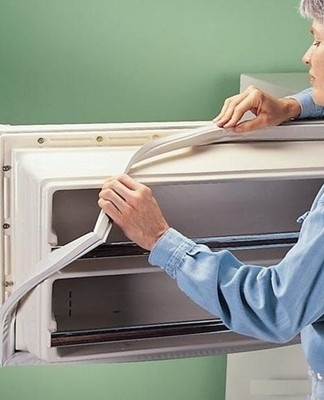 the girl changes the seal in the refrigerator