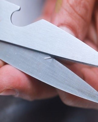 You can sharpen the scissors with a gypsy needle, placing it between the blades as close to the screw as possible.