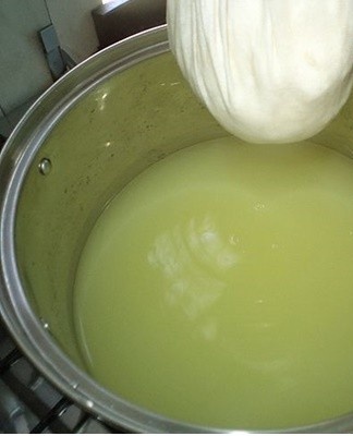 Preheat milk or whey.