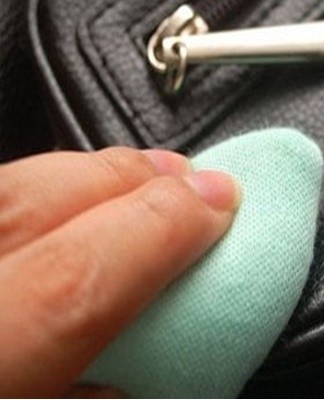 A small amount of cream is spread over the entire ink stain.