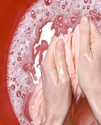 You can only remove traces of cosmetics from delicate fabrics by hand.