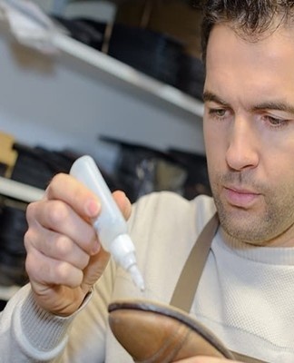 man glues shoes