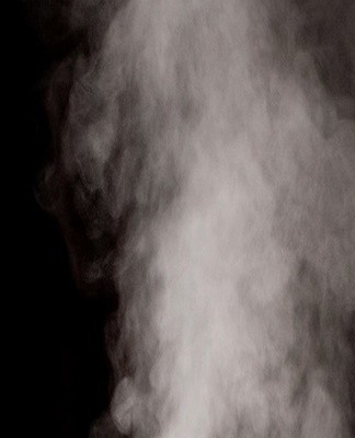 The crumpled clothes are hung over a container filled with boiling water.