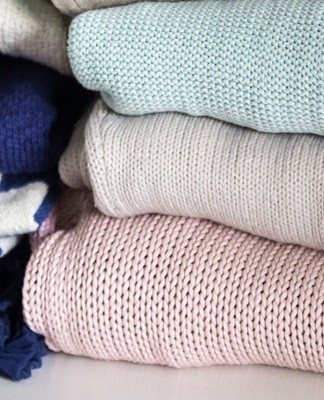 Things are wrung out by hand, laid out on a flat surface under a terry cloth or towel.