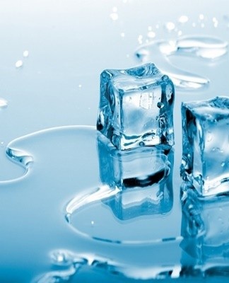 Several ice cubes are placed in a container with cold water and sodium tetraborate is poured.