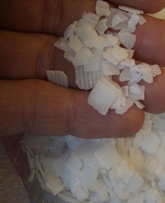 Sodium hydroxide is a strong alkali that attacks plaque