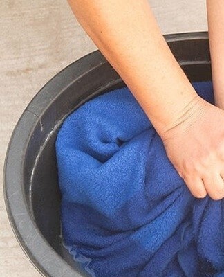 You can remove the smell from clothes using alcohol