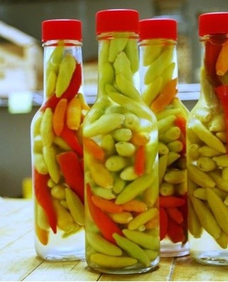 The pods are put in a jar and covered with hot marinade with all the added ingredients.