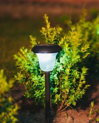 The fluorescent device is connected to a power source and emits light.