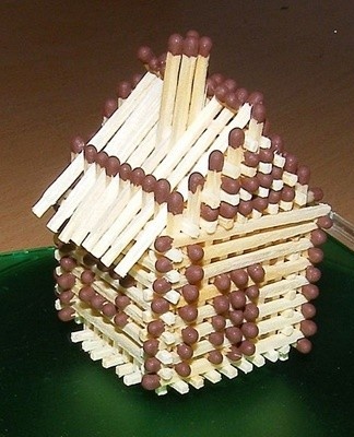 A craft in the form of a house without the use of glue is built on the basis of a standard cube.