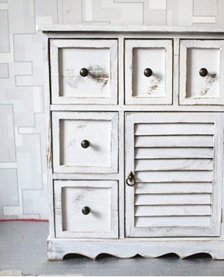 An unusual option would be a small, narrow wardrobe with pull-out shelves.