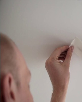 Noticing a hole in the canvas, you need to seal the damaged area with adhesive tape