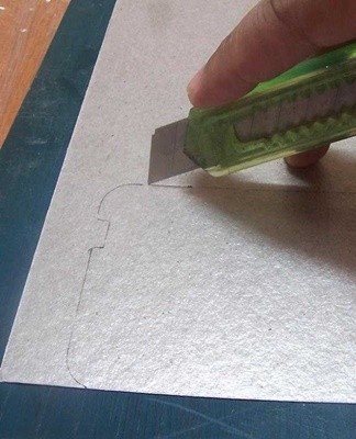 Using a ruler and knife, cut out a new outline and attach rectangular slots.