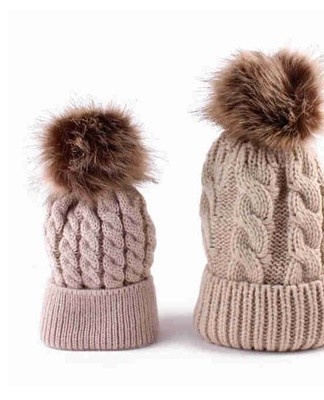 The knitted hat decorated with a pompom has been a trend for several seasons.