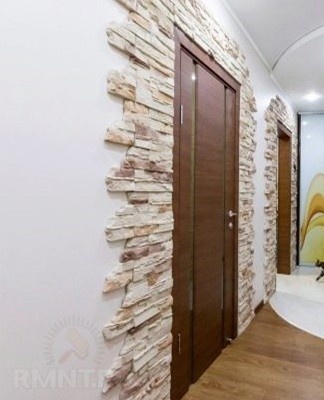 Decorative stone can be successfully combined with most finishing materials, including wallpaper
