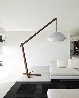 The base of a floor lamp in the loft style is made in the form of a tripod, a lighting beam.