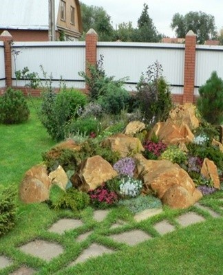 Plants planted in a rock garden are easy to care for, especially if weed roots are removed when digging.