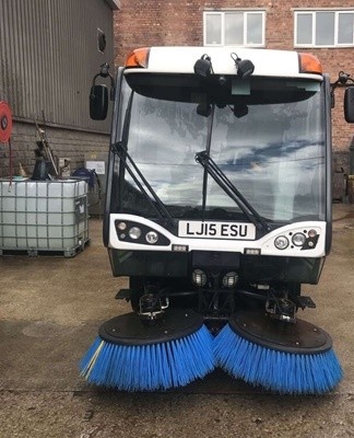 The machine is equipped with sweeping brushes