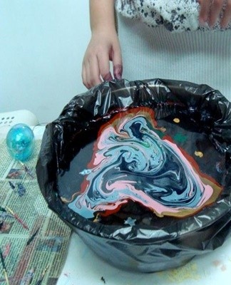 A thin colored film forms on the silk.